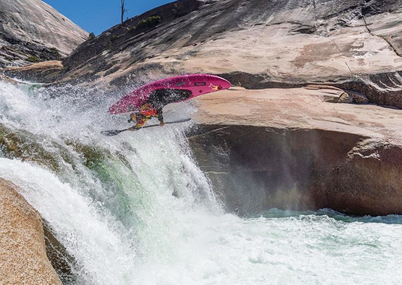 Person flying through whitewater with a Jackson Kayak Flow kayak.